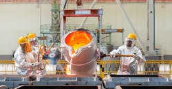 Workers pouring molten metal into sand molds. Workers pouring molten metal into sand molds.