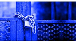 Factory gate closed with padlock. Factory gate closed with padlock.