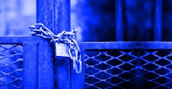 Factory gate closed with padlock. Factory gate closed with padlock.