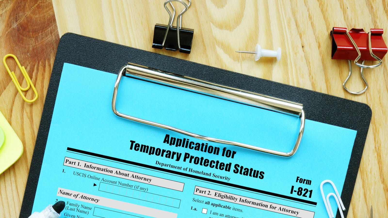An application for Temporary Protected Status on a clipboard.
