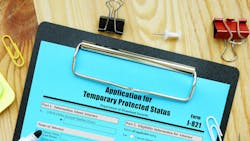 An application for Temporary Protected Status on a clipboard. An application for Temporary Protected Status on a clipboard.