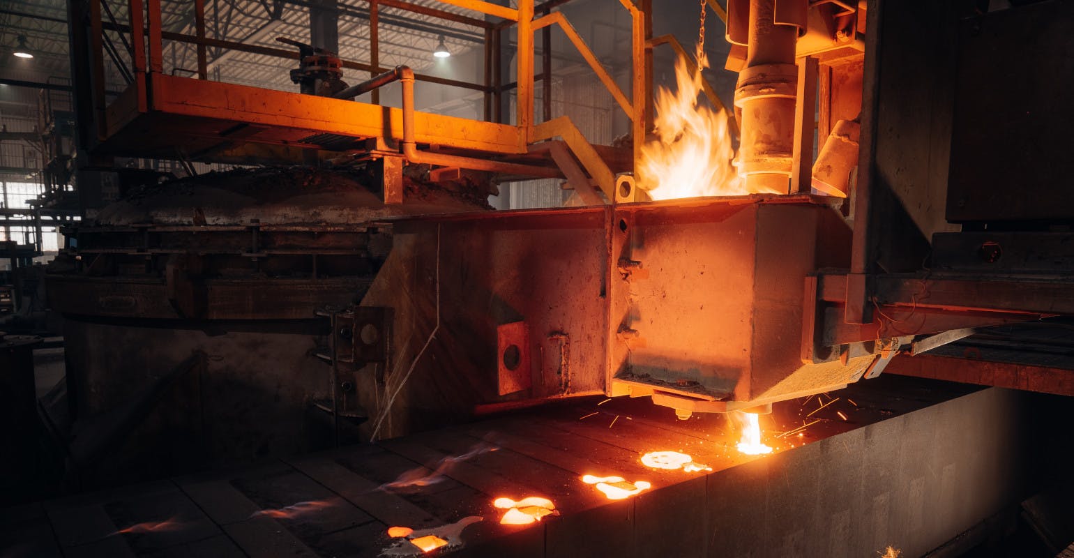 Pouring molten metal into molds.
