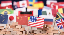 American flag in front of a wall and flags of other countries
