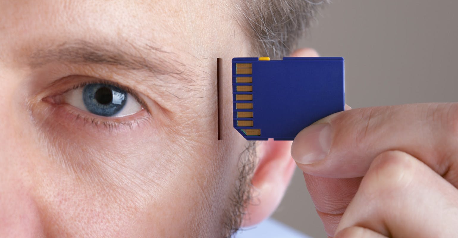 Memory and brain upgrade. Inserting SD memory card into a human head.