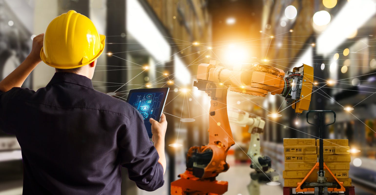 Engineer monitors control automation robot arms.