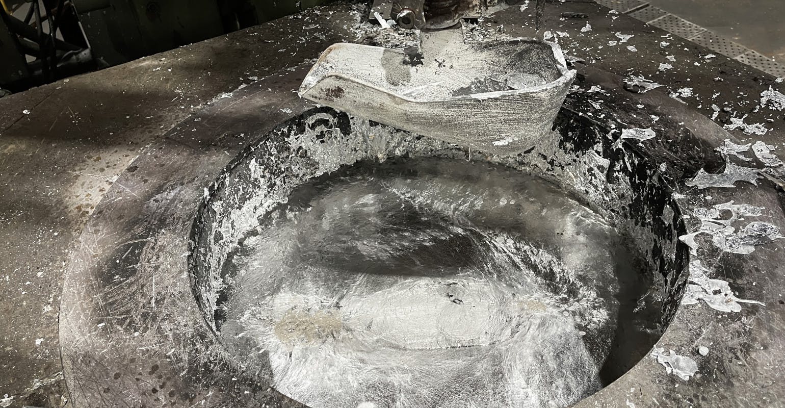 A ladle in an aluminum melting furnace in a diecasting operation.