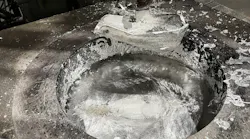 A ladle in an aluminum melting furnace in a diecasting operation.