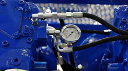 Closeup view of air compressor with pressure gauge.
