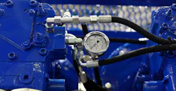 Closeup view of air compressor with pressure gauge.