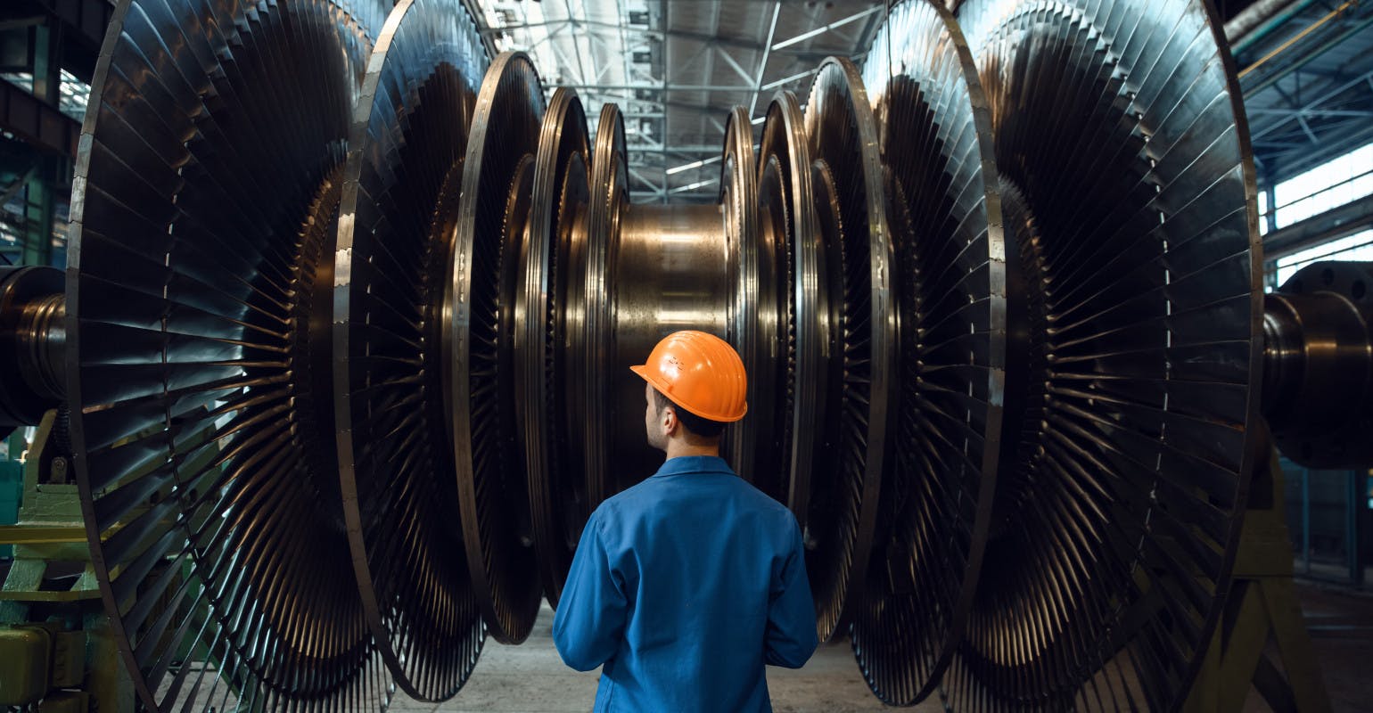 Worker checks turbine impeller vanes.