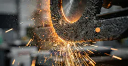 Abrasive cutoff wheel at work on a casting tree.
